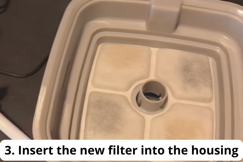 Insert the new Veken Pet Fountain Filter into the housing